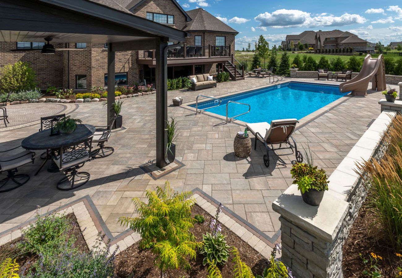 Outdoor Living Patio Pool Deck with Boarders and Retaining Wall