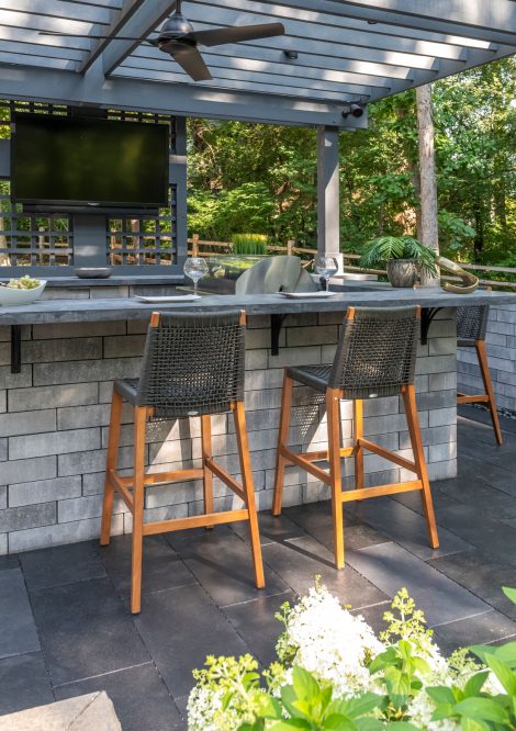 Outdoor Kitchen with High Bar Table and TV Wall