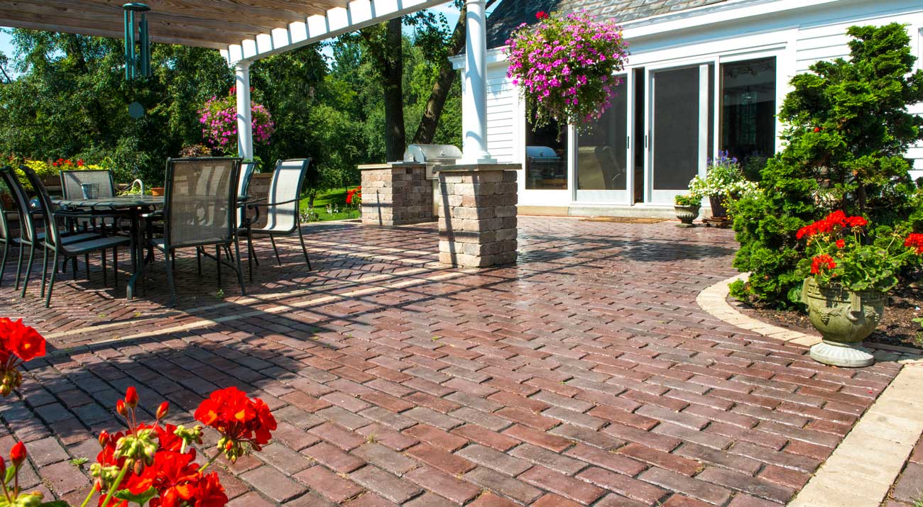 Heritage-inspired patio with Unilock Town Hall Elegance pavers and antiqued pillars