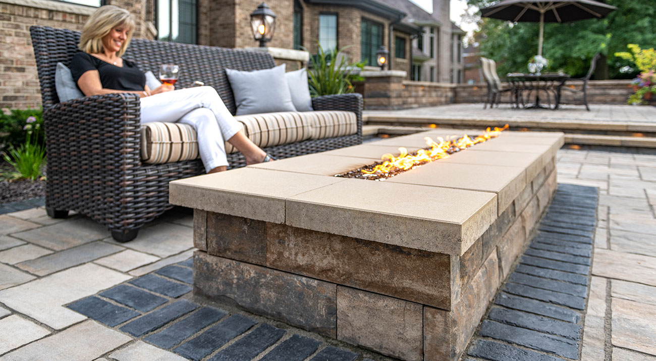Unilock outdoor living space with U-Cara fire feature