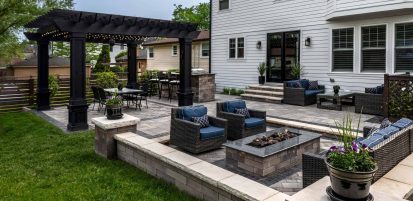 Casual Contemporary Backyard with Unilock Patio with Boarders and Retaining Wall Dividing Space