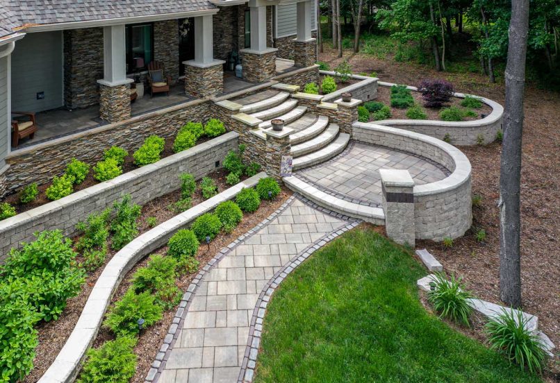 Front Entrance with Walkway to Steps with Multi-Level Retaining Wall Plant Beds and Pillars