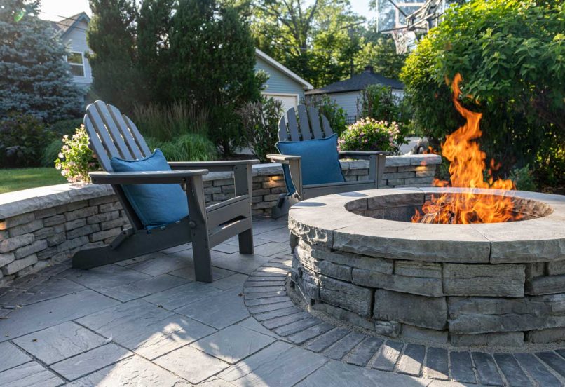 Outdoor Circular Fire Pit with Surrounding Retaining Wall with Lights