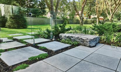 A backyard transformed by Unilock large concrete patio pavers and slabs