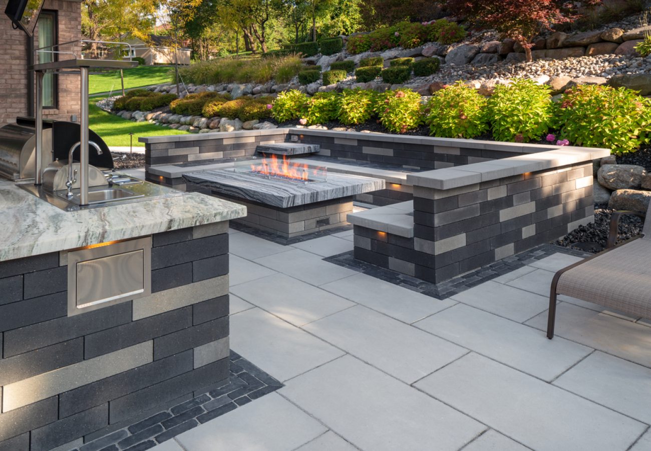 Outdoor Entertainment Space with Retaining Wall Seating around Fire feature and Outdoor Kitchen