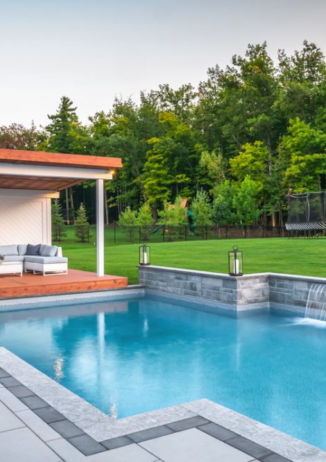 Outdoor Pool with Reatining Wall and Waterfall Feature and Cabana Lounge Area