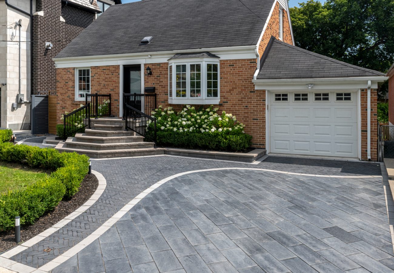 Interlocking Driveway with Curved Boarder Dividing new Paver Section Walkway to Front Entrance