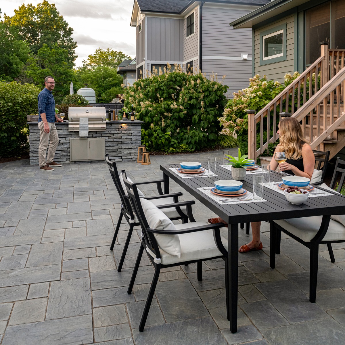 Couple enjoys barbecue on patio pavers