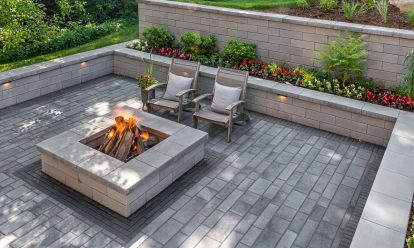 Sunken fire pit with retaining wall and softscaping