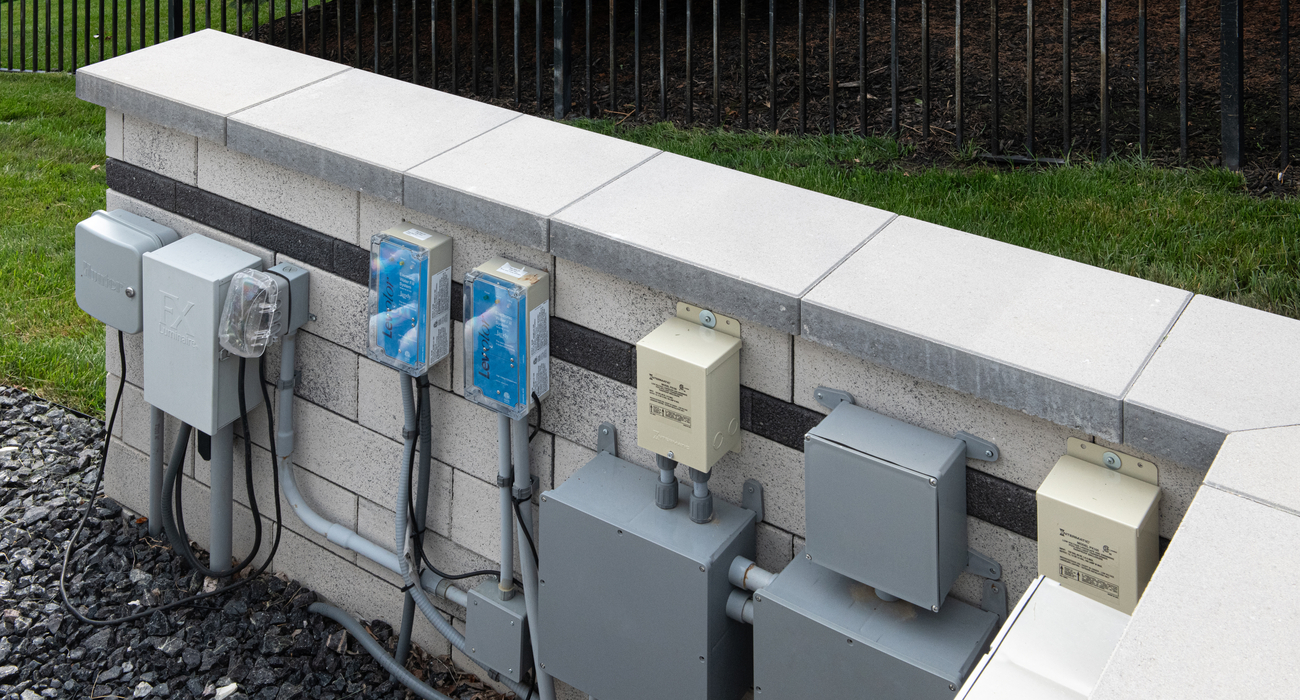 Pool equipment hidden by Unilock retaining wall