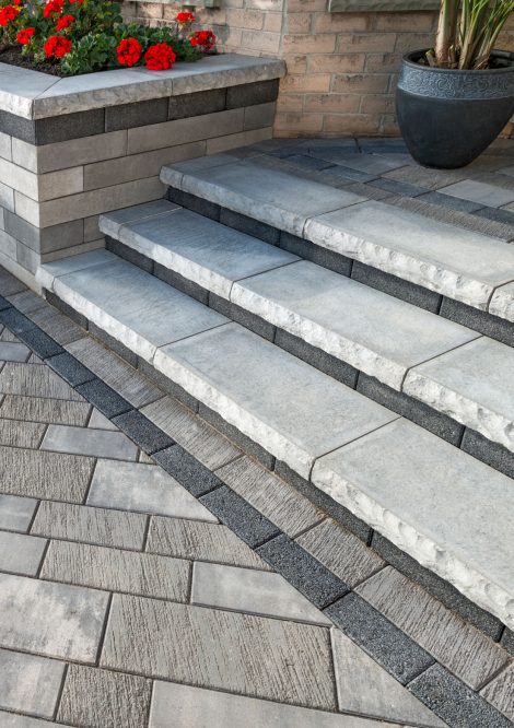 Contemporary Unilock entrance with Artline plank pavers, Ledgestone steps, and Lineo Dimensional Stone garden wall