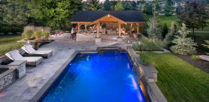 Contemporary Umbriano pool deck with fire feature | Unilock