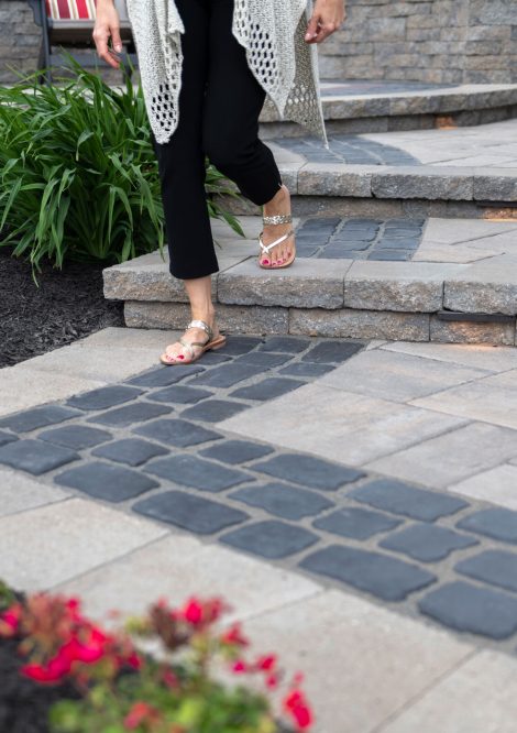 Person Walking down Unilock Paver Steps with Boarders