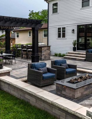 Casual Contemporary Backyard with Unilock Patio with Boarders and Retaining Wall Dividing Space