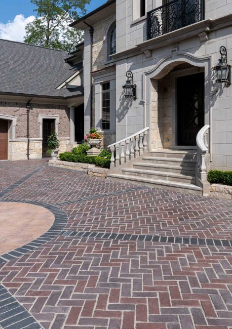 Unilock Driveway with Unique Design and Retaining Wall Plant Beds at Front Entrance