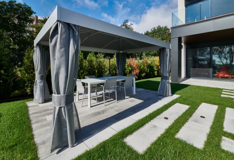 Outdoor Unilock Patio with Gazebo Shade and Walkway with Spaced Pavers on Grass