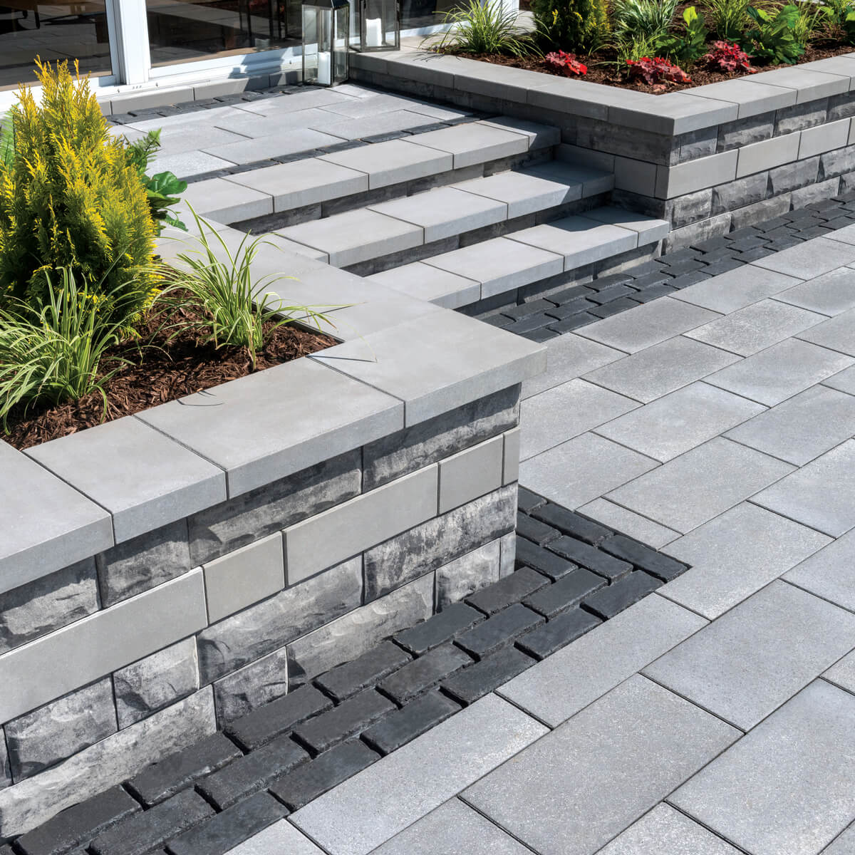 Unilock Retaining Wall Plant Beds in Backyard Patio