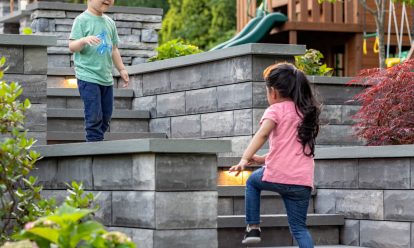 Children Walking on Unilock Steps with Lighting and Multi-Level Retaining Walls