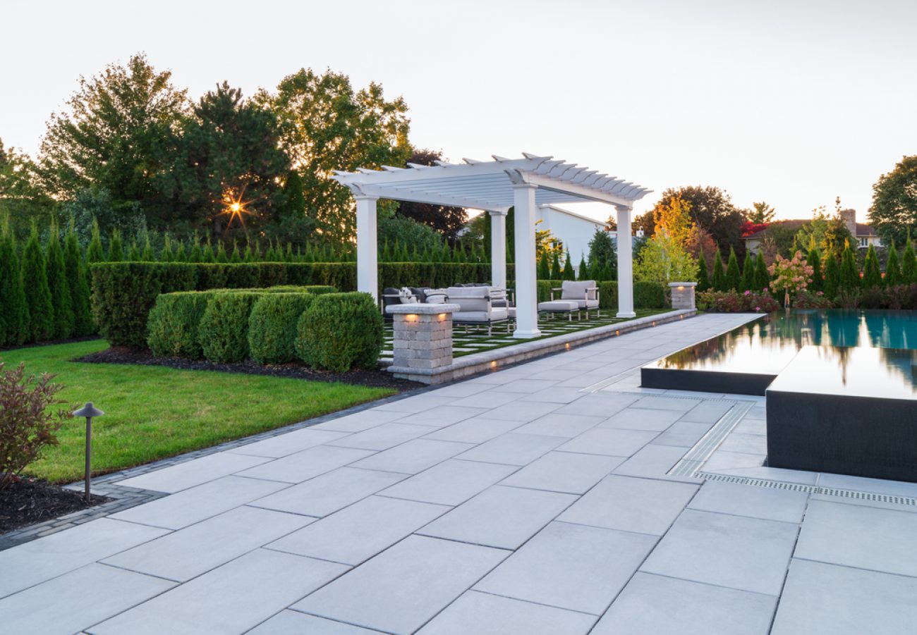 Outdoor Patio with Sleek Unilock Pavers around Raised Pool