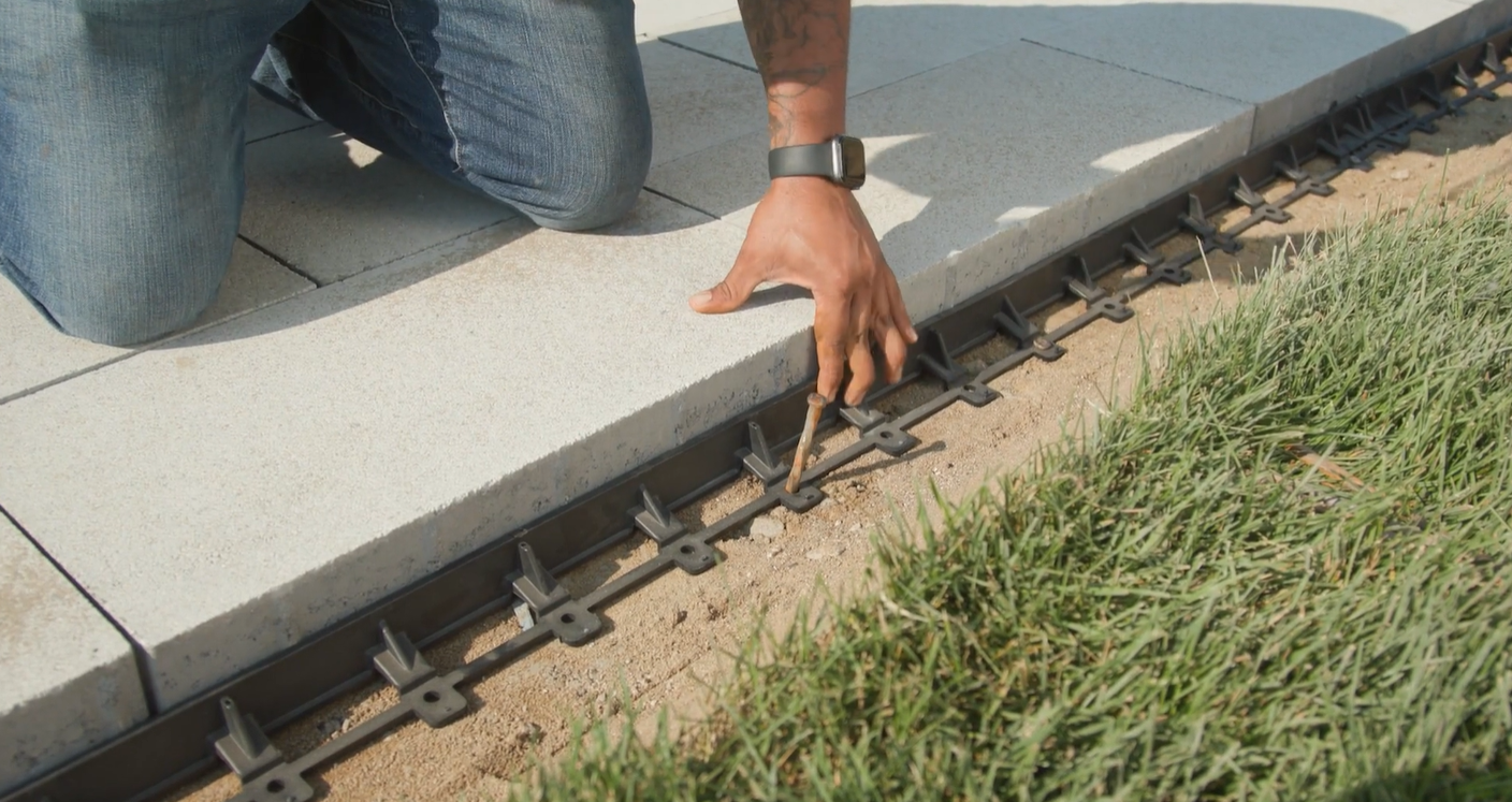 Close up of plastic paver edge restraints