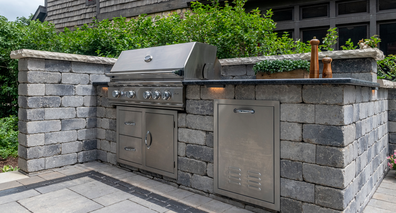 Outdoor kitchen on backyard paver patio