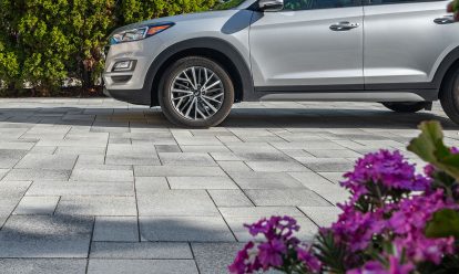 Paver driveway closeup with vehicle with background