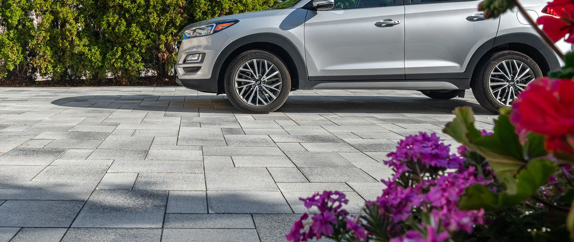 Paver driveway closeup with vehicle with background