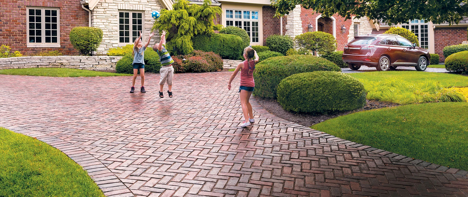 Children playing on paver driveway