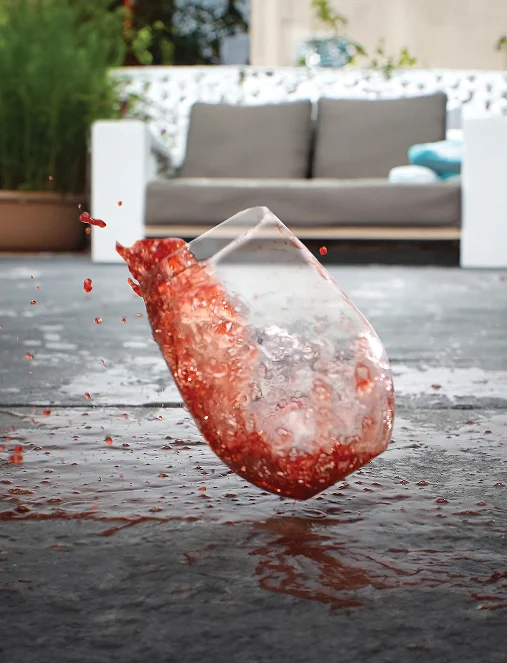 Wine glass spilling on paver patio with EasyClean stain resistance