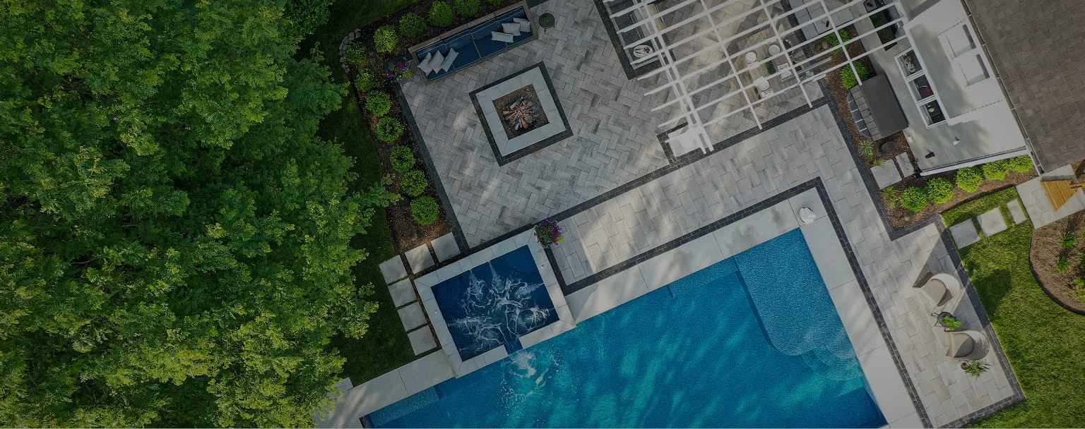 Paver patio aerial view with swimming pool and coping