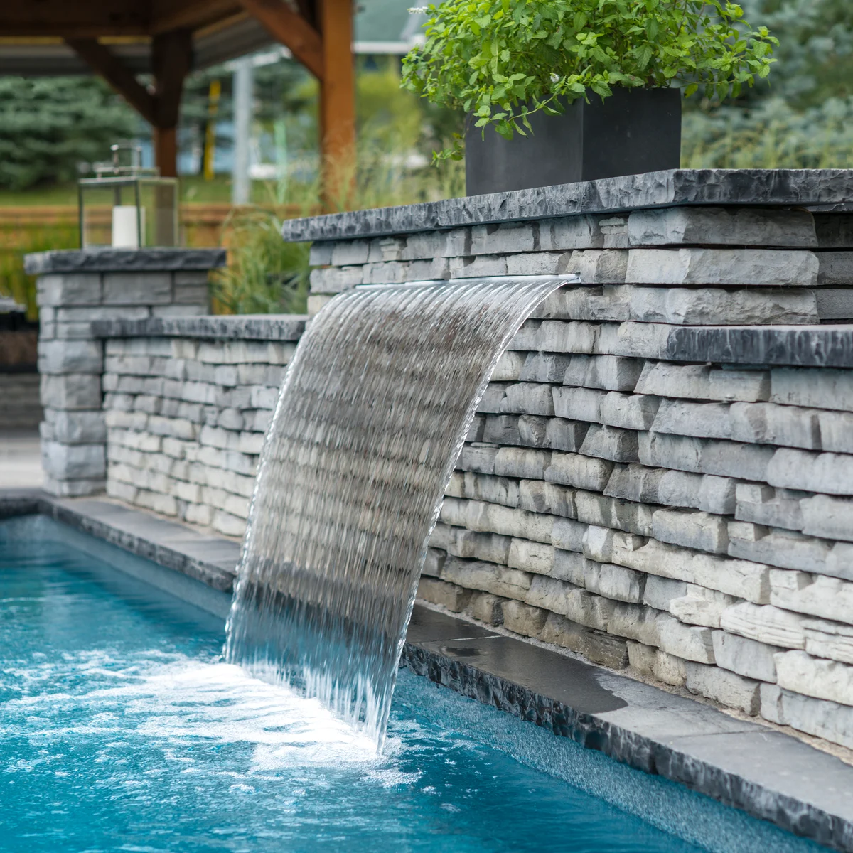Natural Stone water feature and pool coping