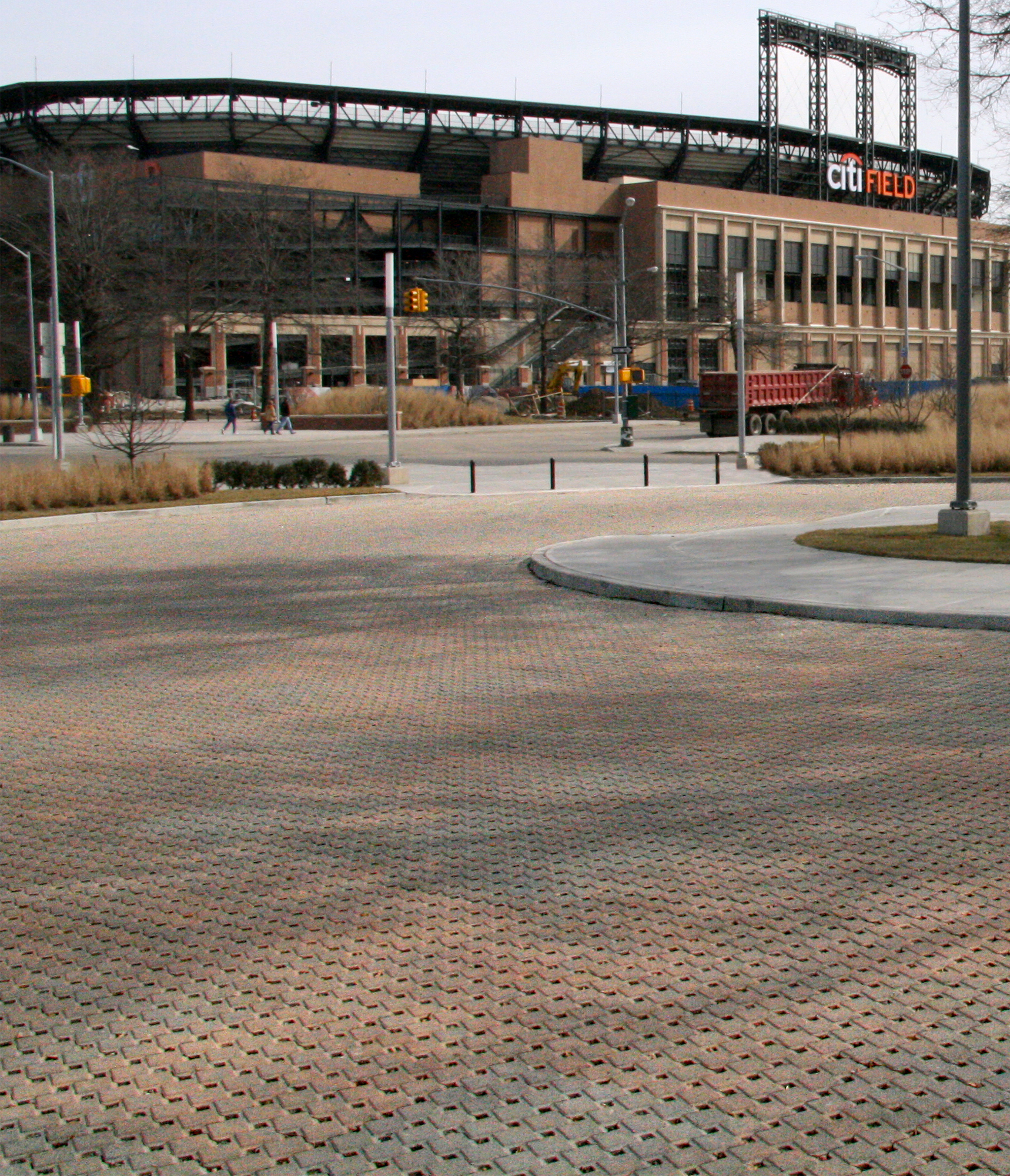 Ecoloc pavers in a reddish-blue hue is used in the parking lot outside City Field Met Stadium, matching the color tone of the building.
