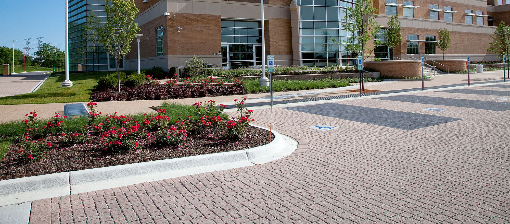 The landscaped parking lot in front of the Aurora police station is paved with Eco-Optiloc in contrasting colors to delineate parking spots.