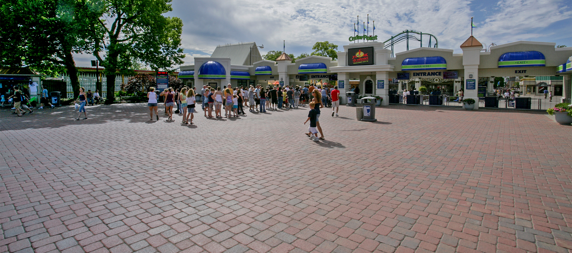 An expansive bed of Camelot pavers in a reddish-blue hue provides a comfortable surfaces for guests awaiting entry to Cedar Point.