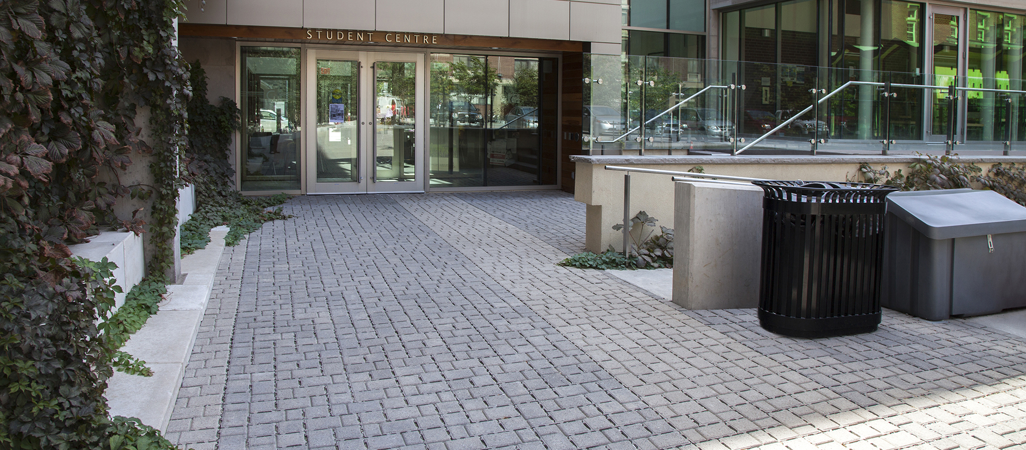 Grey Eco-Optiloc pavers achieve a subtle tonal balance with the surrounding architecture leading to the front entrance.