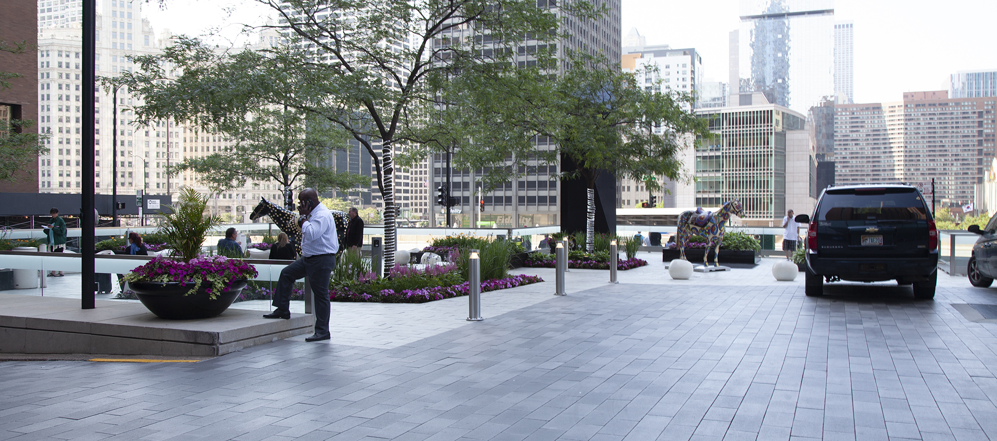 The Hyatt Regency hotel in Chicago features a courtyard with Senzo pavers, lighting, gardens, and a colorful horse sculpture.