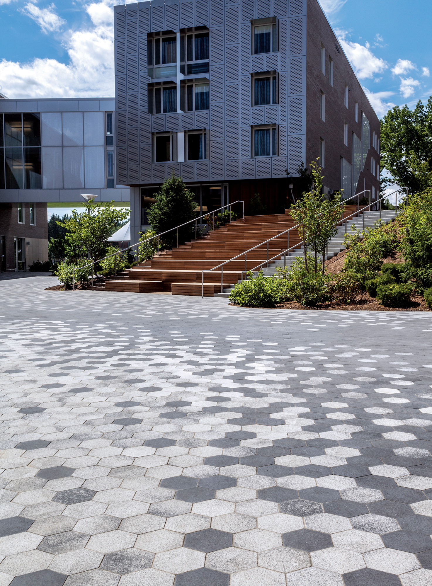 Descending the staircase leads to a pixelated walkway design using two-toned hexagonal City Park Paver™.