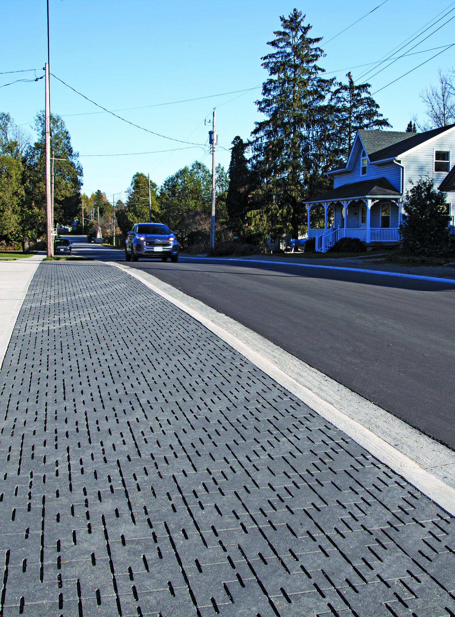 Parking lane on a residential street paved with Unilock Dura-Flow permeable pavers.