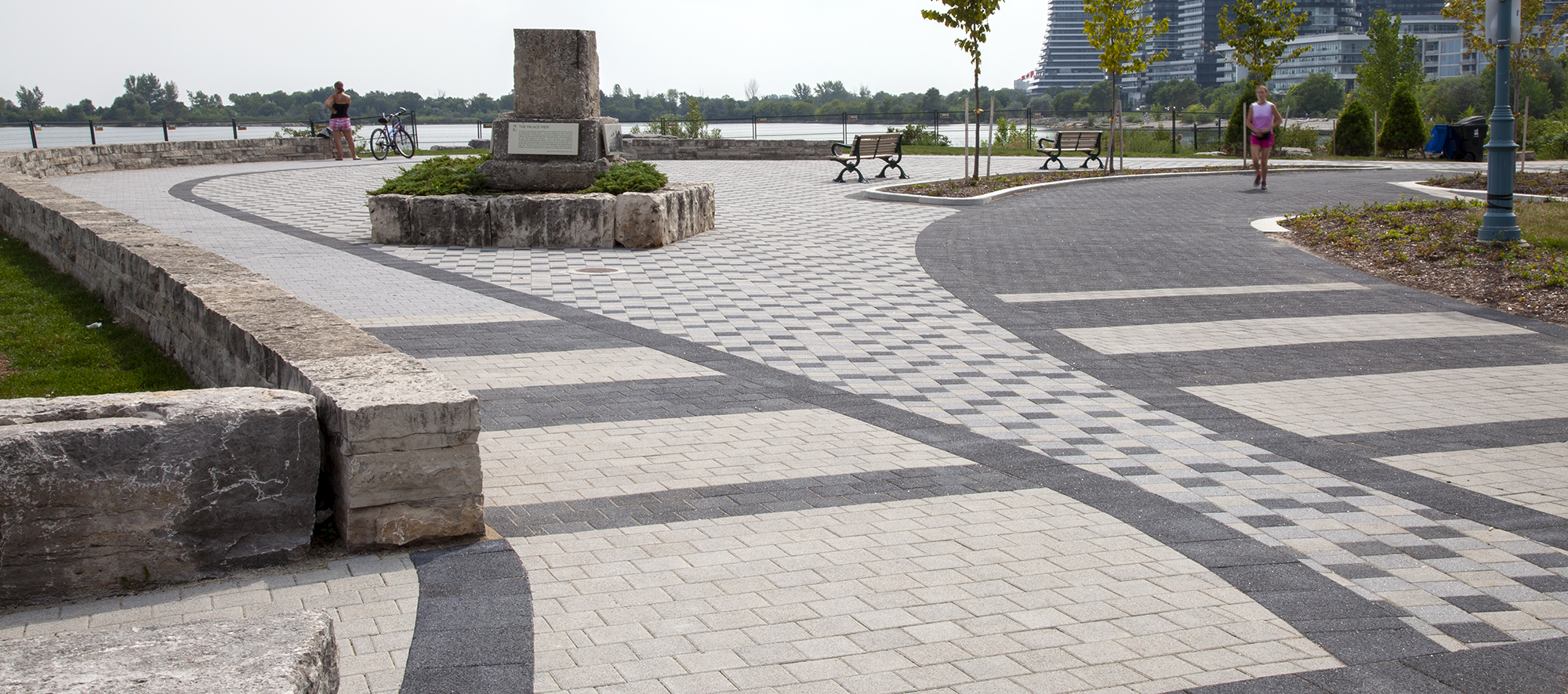 Tri-colored Series pavers create a stunning checkerboard pattern shoreside, as joggers pass by on either side of the paver rug.