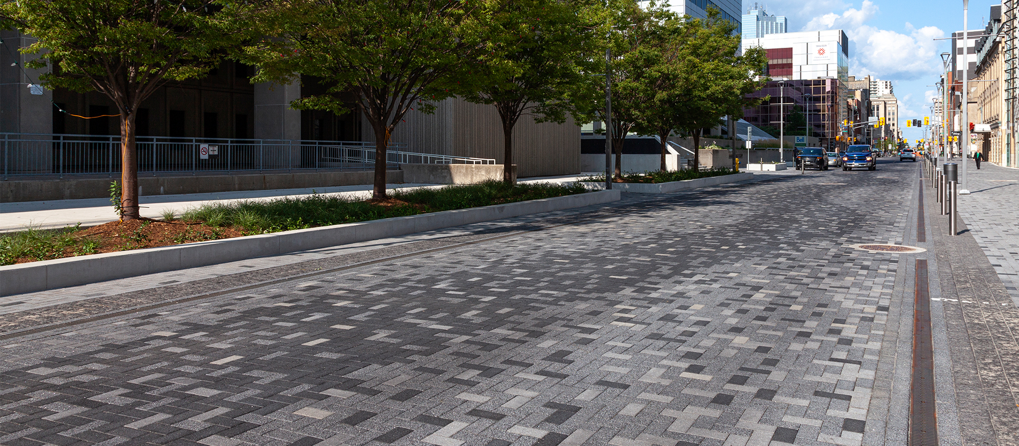 Dundas Place streetscape features Series pavers in pixelated patterns, a curvy zig-zag in the center, and landscaping.