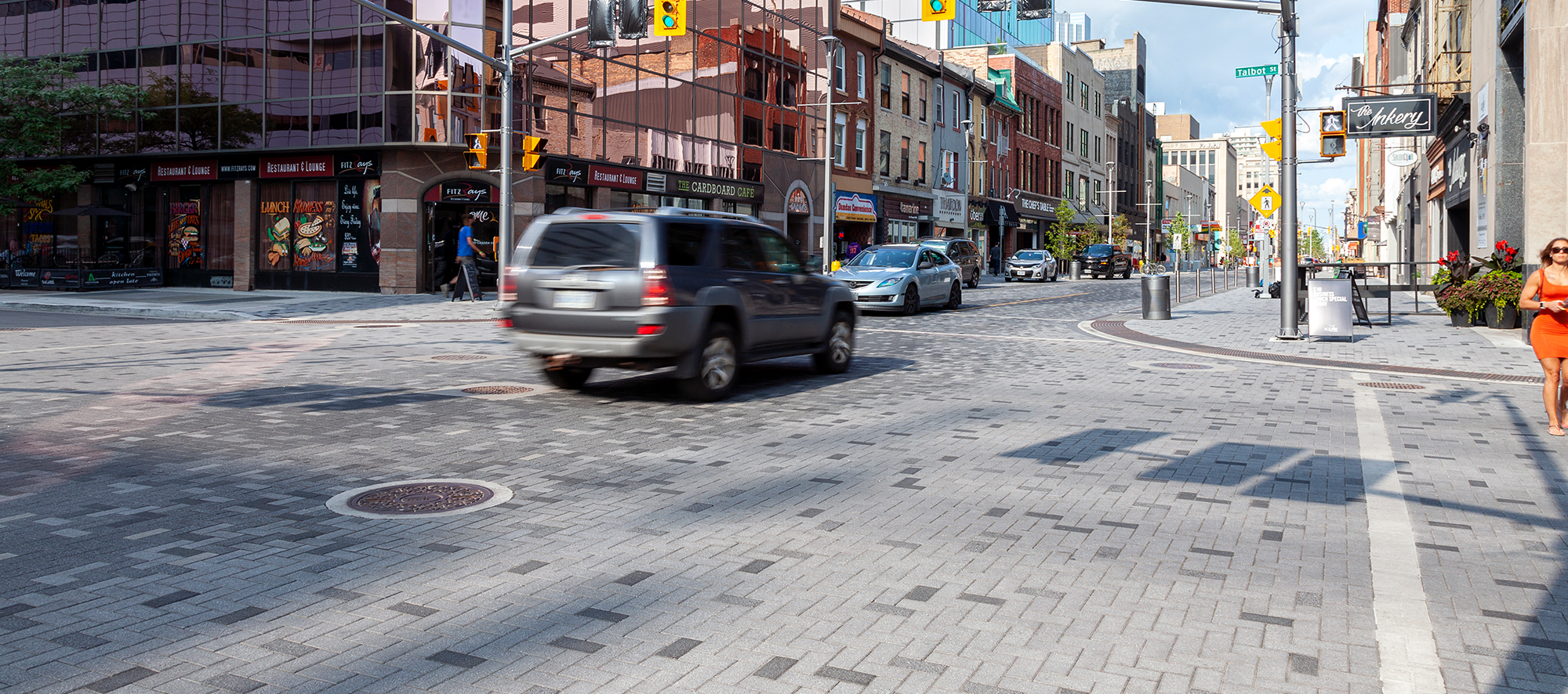 A busy intersection at Dundas Place streetscape features Series pavers in pixelated patterns, with contrasting colors for cars and walking.