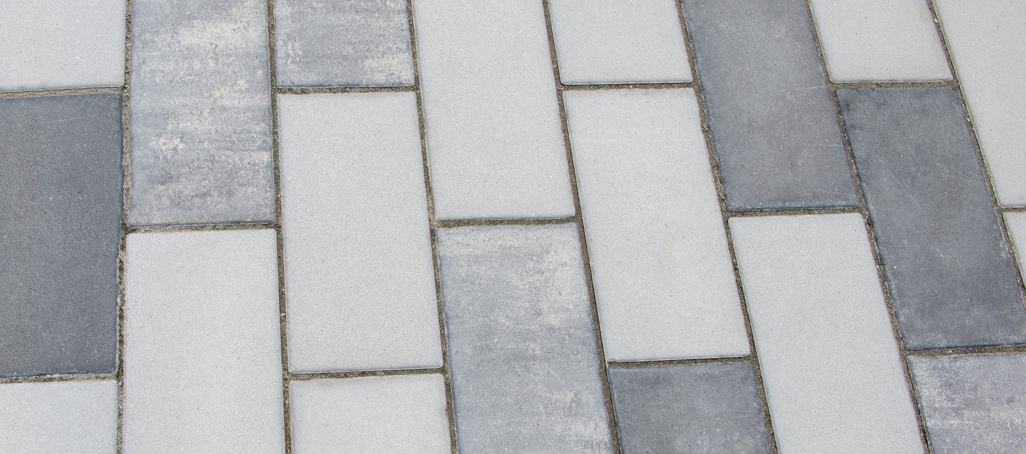 Promenade Plank pavers in three distinct, muted tones create a unique design that is sporadic in appearance.