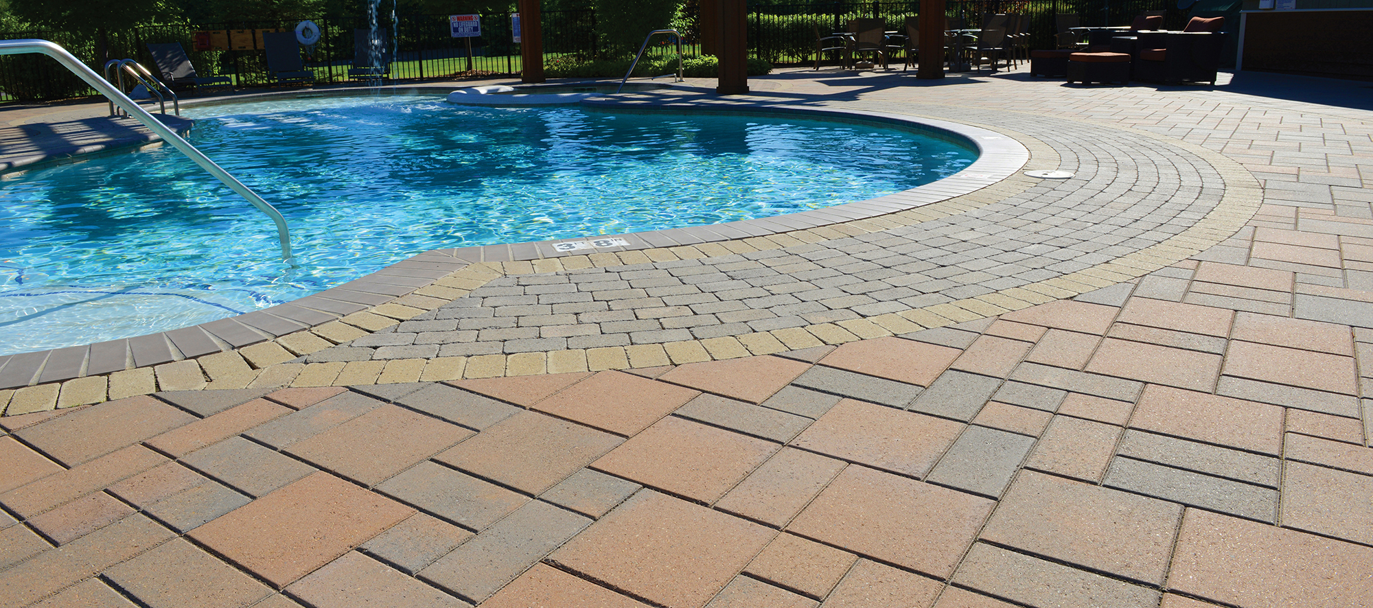 Around the pool, a warm blend of Unilock Brussels Block pavers in unique patterns make walking areas at Hearthside Grove Motorcoach Resort.